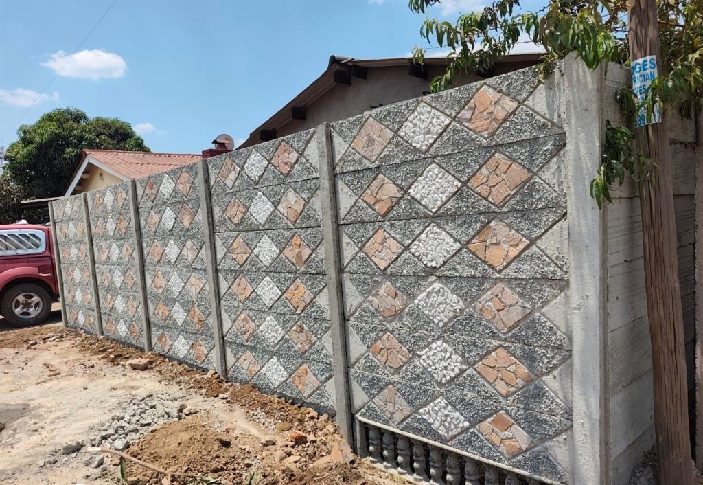 Decorative stone-pattern precast boundary wall by Native Walls